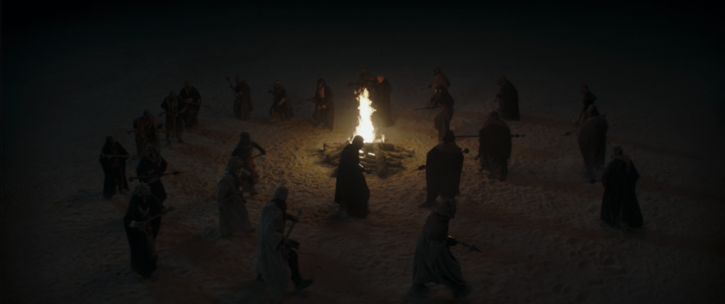 The Tusken tribe dances around the fire