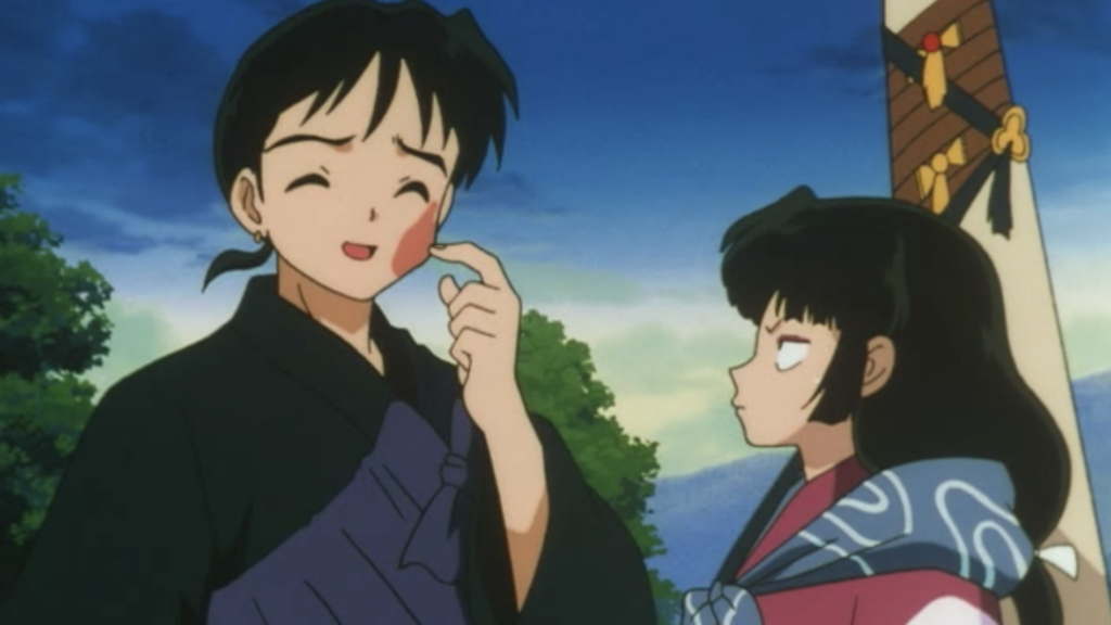 An angry Sango glares at a freshly slapped Miroku